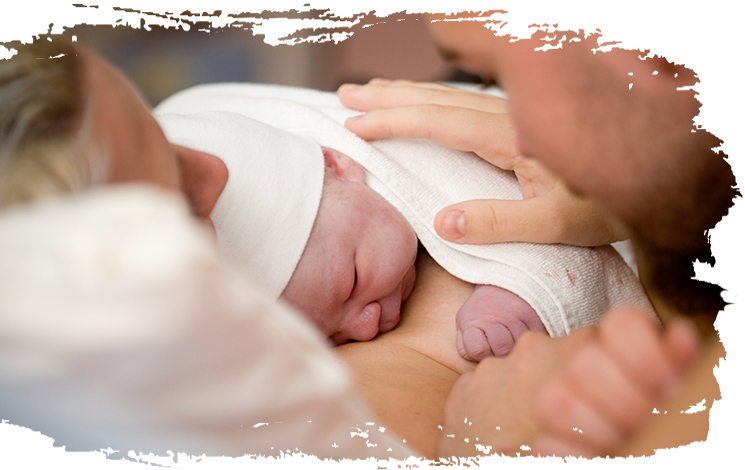a newborn baby on it's mothers chest