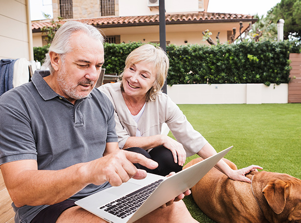 an older couple looking at a laptop screen