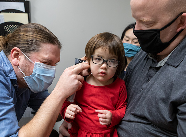a kid getting her ears checked