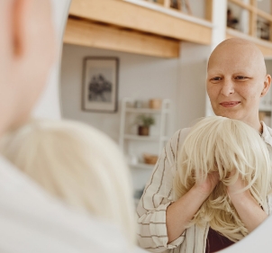 cancer patient holding a wig